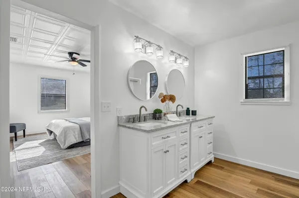 a bathroom with a double vanity sink and a mirror
