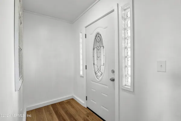 a living room with furniture a rug and a ceiling fan