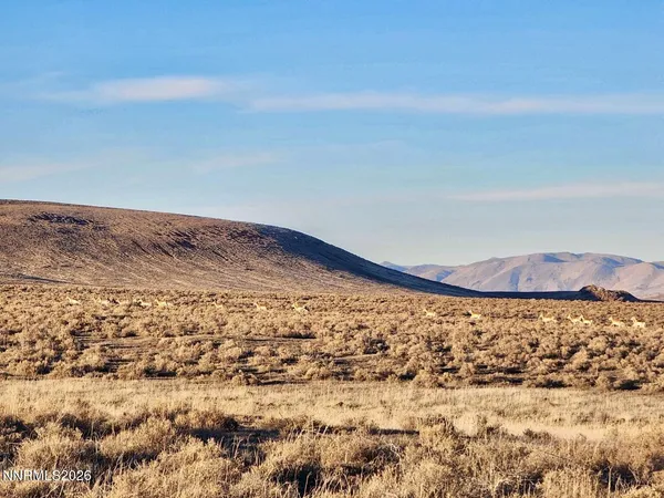 a view of a large mountain with a mountain in the background