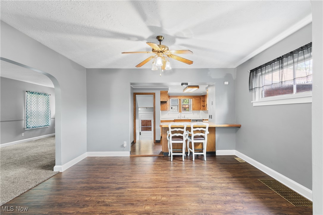 302 Poplar Avenue Northwest Canton, OH 44708 - Photo 12 of 34 Living room featuring arched walkways, plenty of natural light, a ceiling fan, and dark wood-type flooring