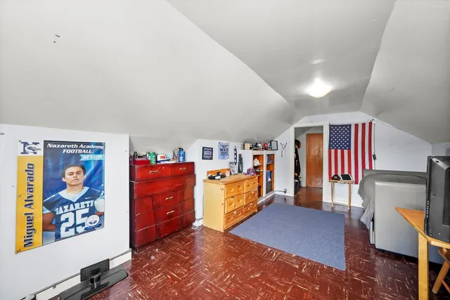 a living room with furniture and a baby crib