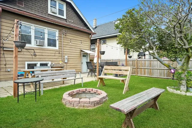 a backyard of a house with table and chairs