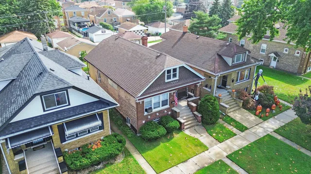 an aerial view of multiple houses with yard