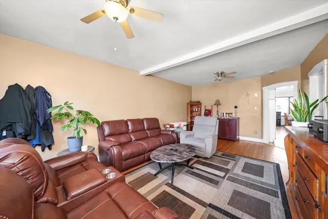a living room with furniture and a chandelier