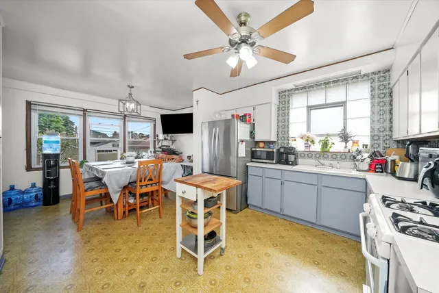 a kitchen with a table chairs stove and refrigerator