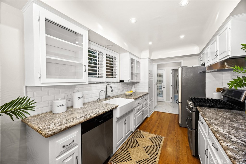 378 Patterson Drive Monrovia, CA 91016 - Photo 13 of 42 a kitchen with granite countertop a sink a counter space and stainless steel appliances