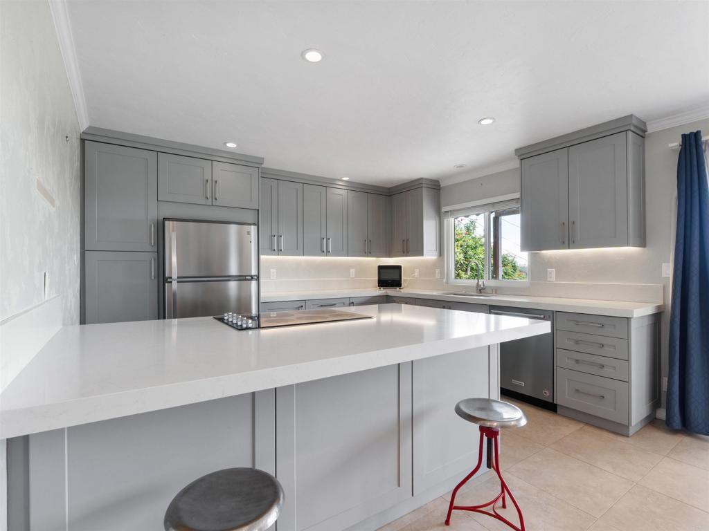 852 Dewitt Avenue Encinitas, CA 92024 - Photo 14 of 41 a kitchen with counter top space cabinets and stainless steel appliances