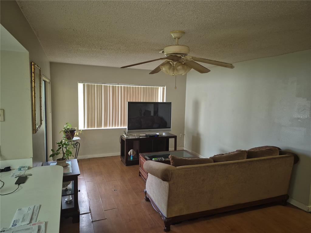 13710 Whitby Road Hudson, FL 34667 - Photo 12 of 21 a living room with furniture and a flat screen tv