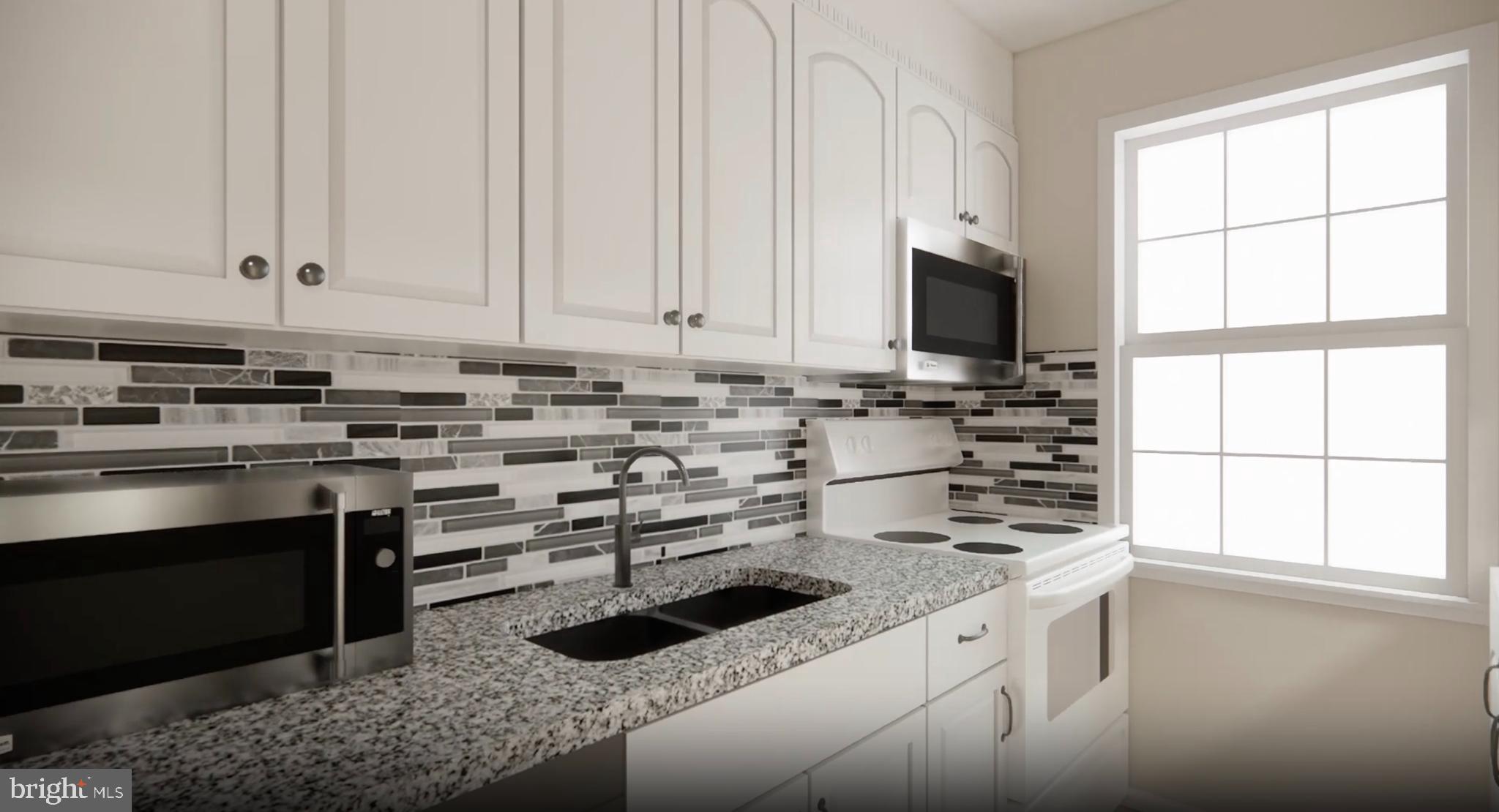 2213 Washington Avenue, Unit 101 Silver Spring, MD 20910 - Photo 7 of 25 a kitchen with stainless steel appliances a stove a sink and white cabinets