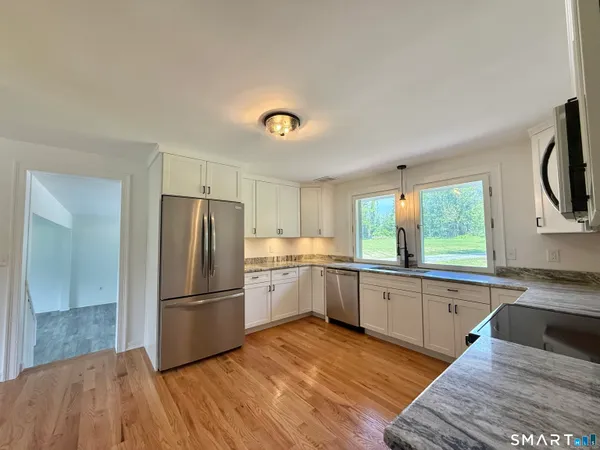 a kitchen with a refrigerator and a sink