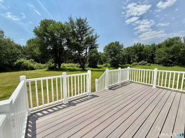 a balcony with wooden floor and fence
