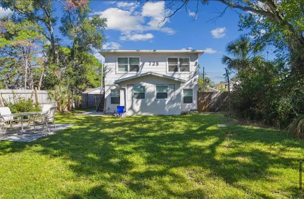 a front view of house with yard and green space