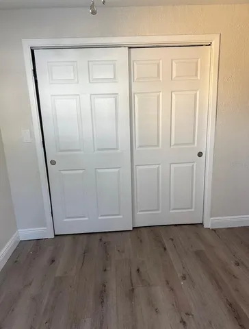 an empty room with wooden floor