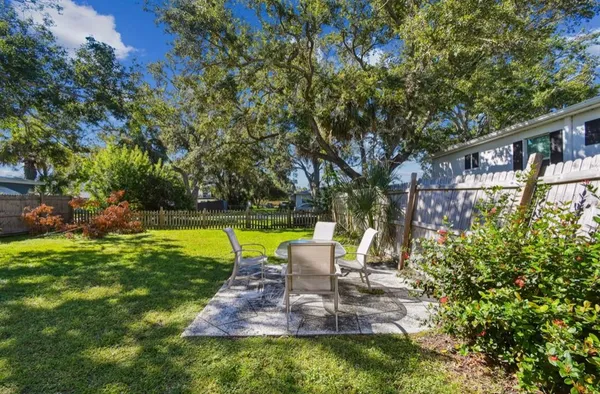 a view of a house with a yard patio and swimming pool