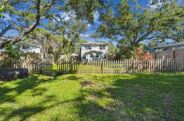 a view of a house with a yard and plants