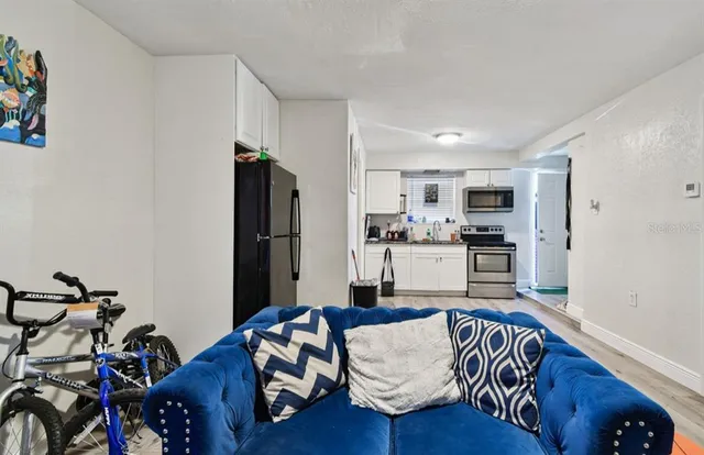 a living room with furniture and kitchen view