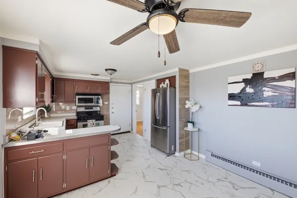 a large kitchen with granite countertop a stove and refrigerator