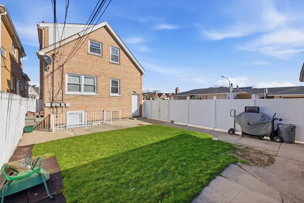 a view of a house with a yard and sitting area