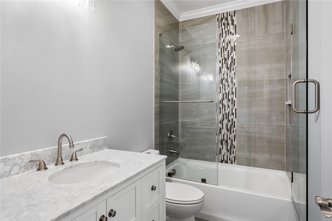 303 Regency Circle Anderson, SC 29625 - Photo 39 of 50 This updated bath features a shower-over-tub design, sleek glass partition, and a chic vanity.