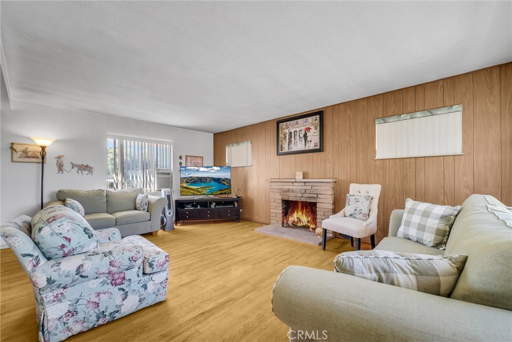 2551 Rome Avenue Anaheim, CA 92804 - Photo 6 of 27 a living room with furniture a fireplace and a flat screen tv
