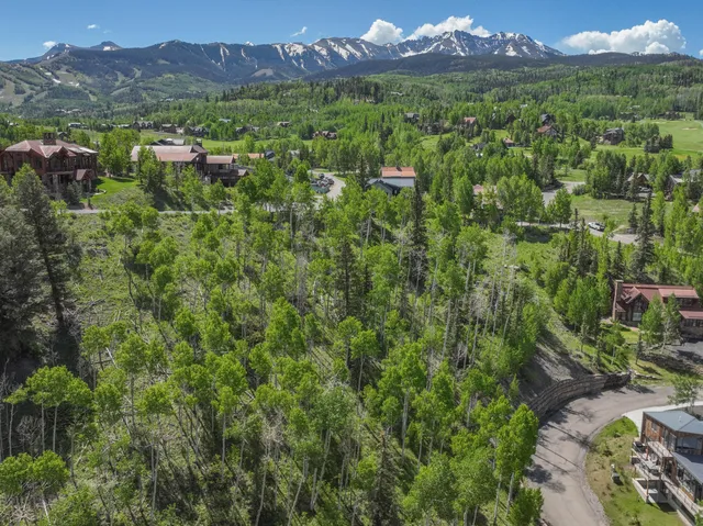 an aerial view of residential house with outdoor space and mountain view