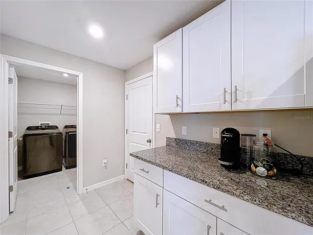 a kitchen with stainless steel appliances kitchen island granite countertop a sink and cabinets