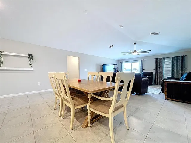 a bed room with a bed and a ceiling fan