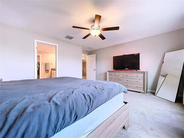 a view of workspace with furniture and ceiling fan