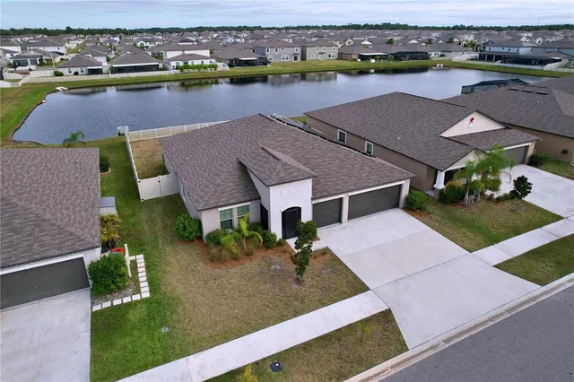 an aerial view of house with yard and ocean view