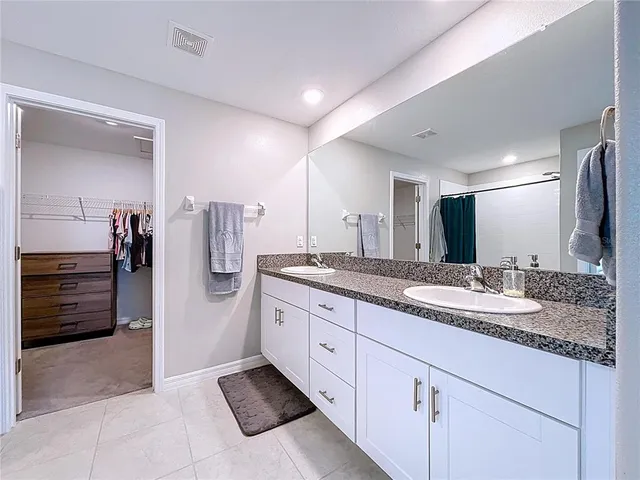 a bedroom with a bed and a ceiling fan