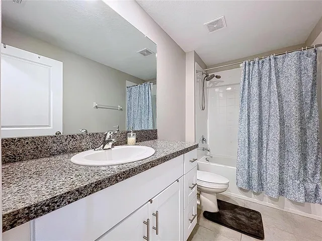 an aerial view of residential houses with outdoor space and swimming pool