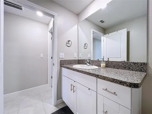 an aerial view of residential houses with outdoor space and lakeside