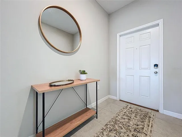 a view of a livingroom with furniture and mirror