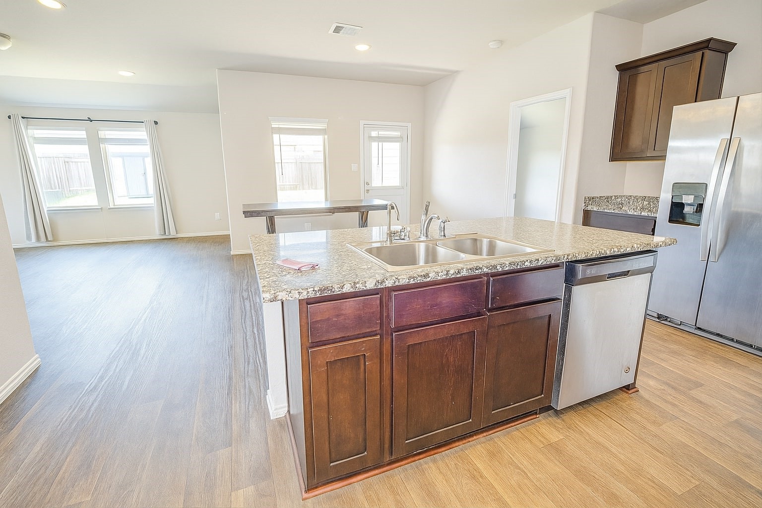 1714 Cooper Bluff Court Rosenberg, TX 77469 - Photo 2 of 21 a kitchen with stainless steel appliances granite countertop a sink a microwave refrigerator and wooden floor