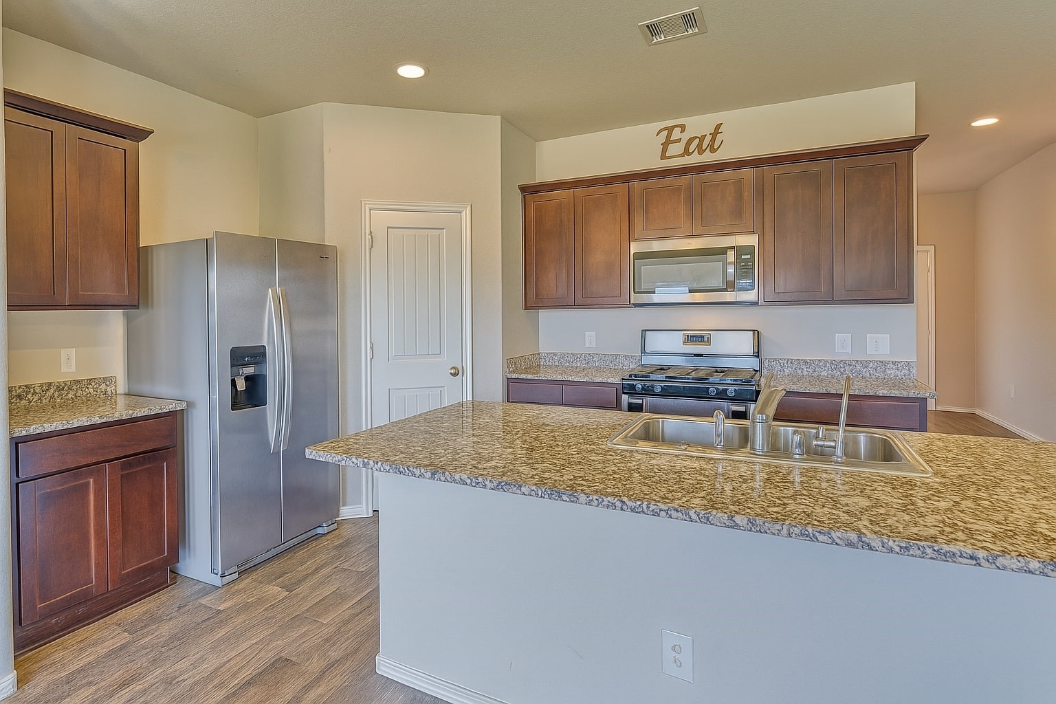 1714 Cooper Bluff Court Rosenberg, TX 77469 - Photo 3 of 21 a kitchen with a refrigerator sink and cabinets