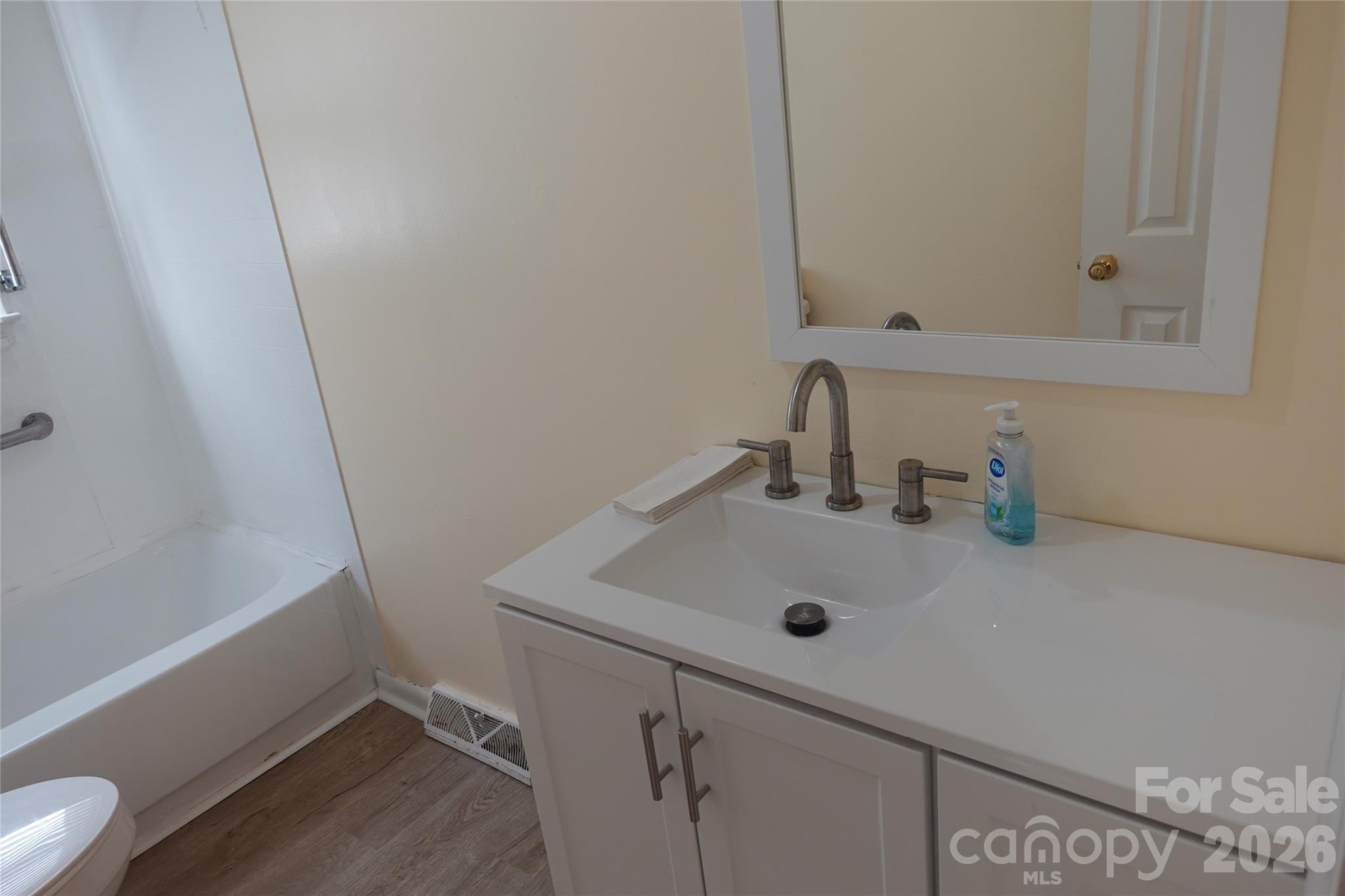 155 Robbins Street Southwest Concord, NC 28025 - Photo 13 of 19 a bathroom with a sink and a mirror