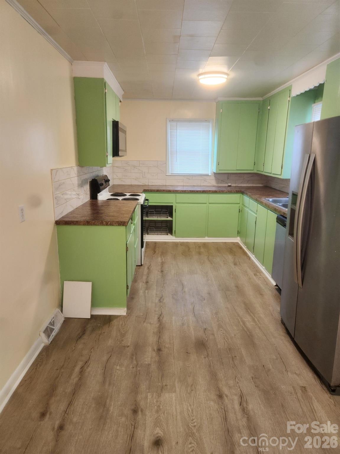 155 Robbins Street Southwest Concord, NC 28025 - Photo 14 of 19 a kitchen with a refrigerator and a sink