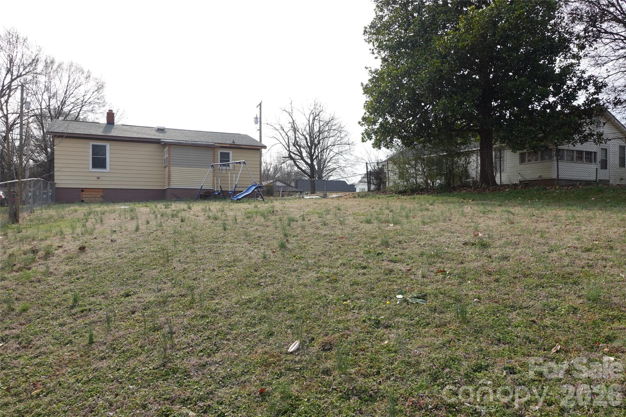 155 Robbins Street Southwest Concord, NC 28025 - Photo 4 of 19 a backyard of a house with lots of green space