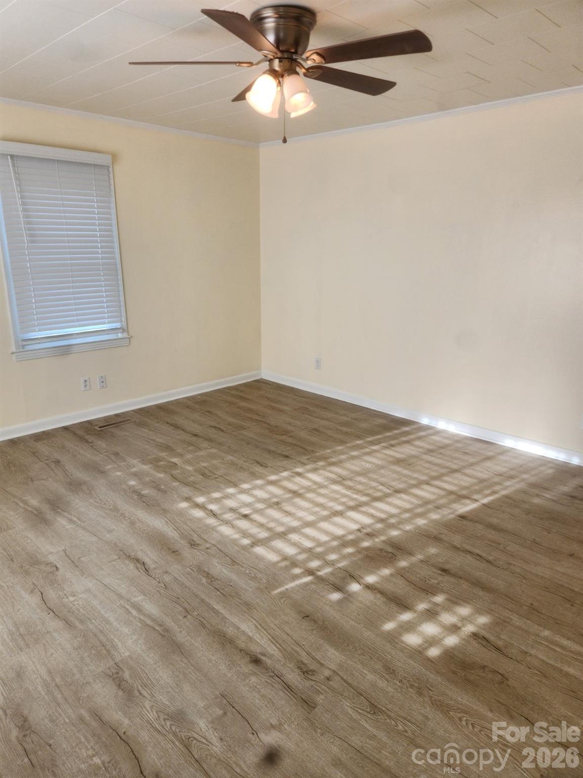 155 Robbins Street Southwest Concord, NC 28025 - Photo 9 of 19 a view of an empty room with window and wooden floor
