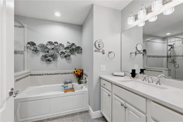 a bathroom with a bathtub sink and mirror