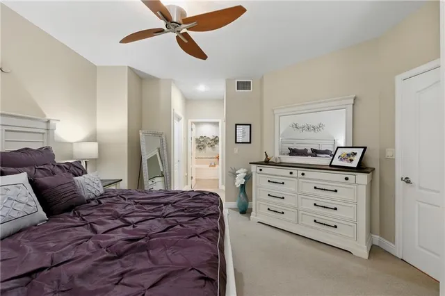a bedroom with a large bed and a chandelier
