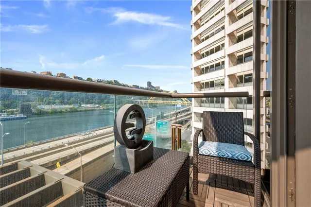 a front view of a house with lake view and a chair