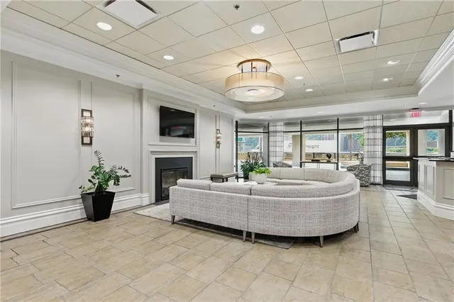a living room with fireplace furniture and a flat screen tv