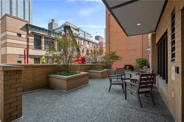 a building outdoor space with patio furniture and potted plants