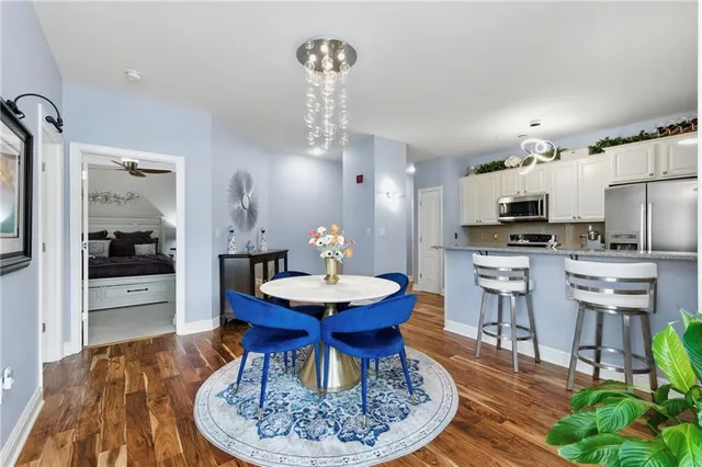 a dining room with furniture and wooden floor