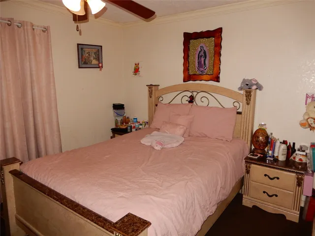 a bedroom with a bed and a dresser in it