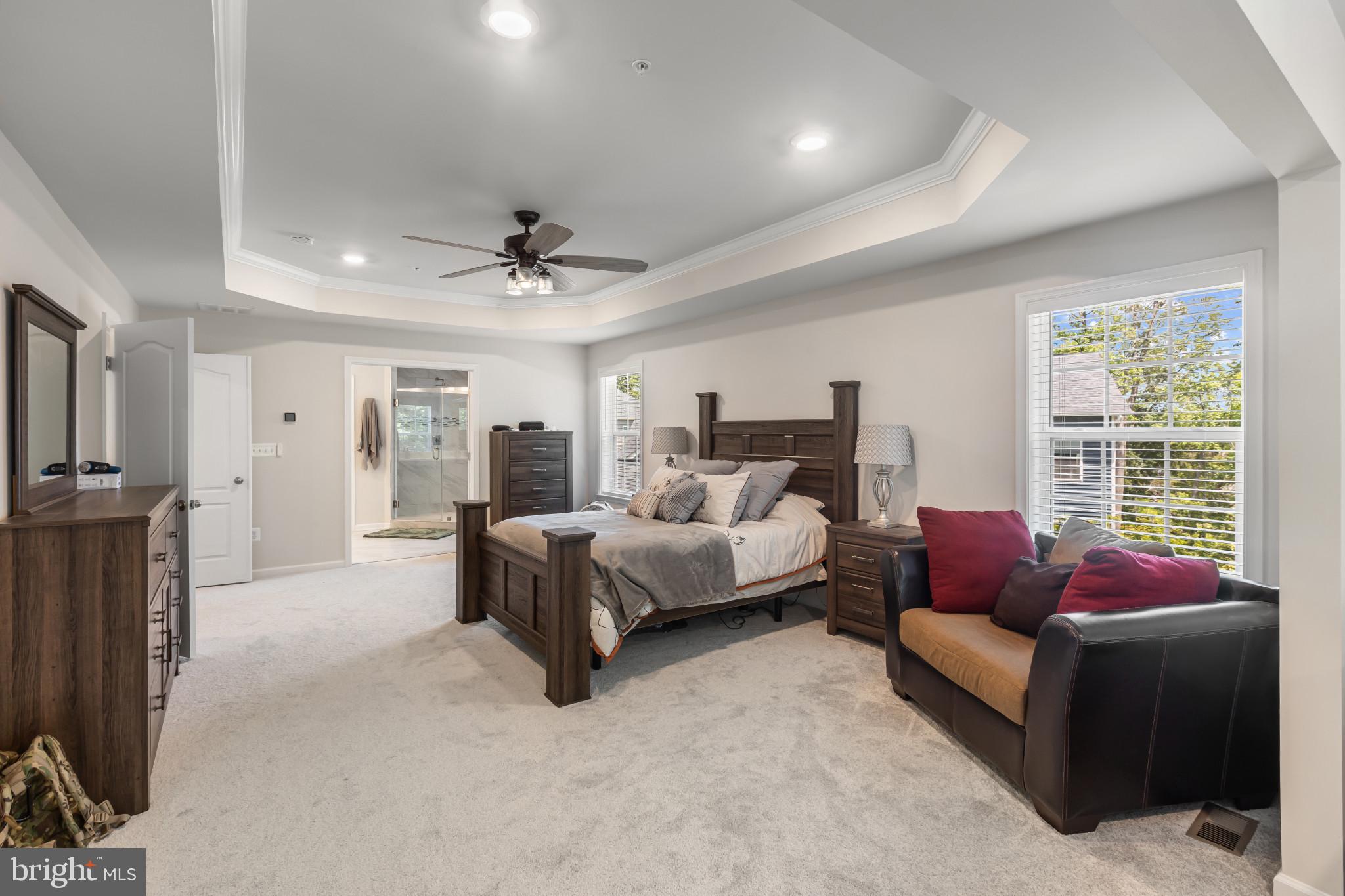 9909 Kildore Way Fort Washington, MD 20744 - Photo 26 of 43 a spacious bedroom with a bed and a couch