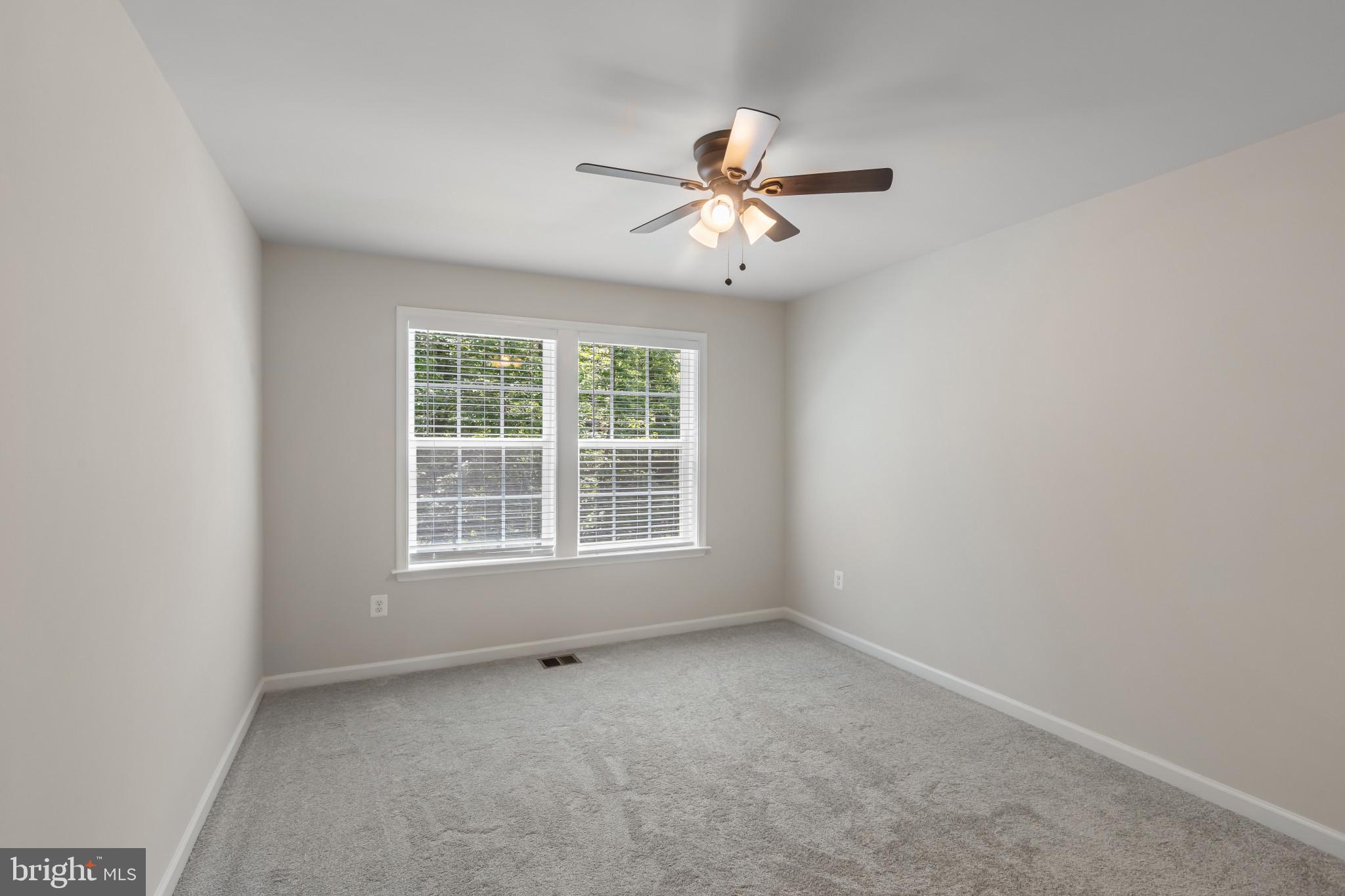 9909 Kildore Way Fort Washington, MD 20744 - Photo 28 of 43 an empty room with a window and a fan