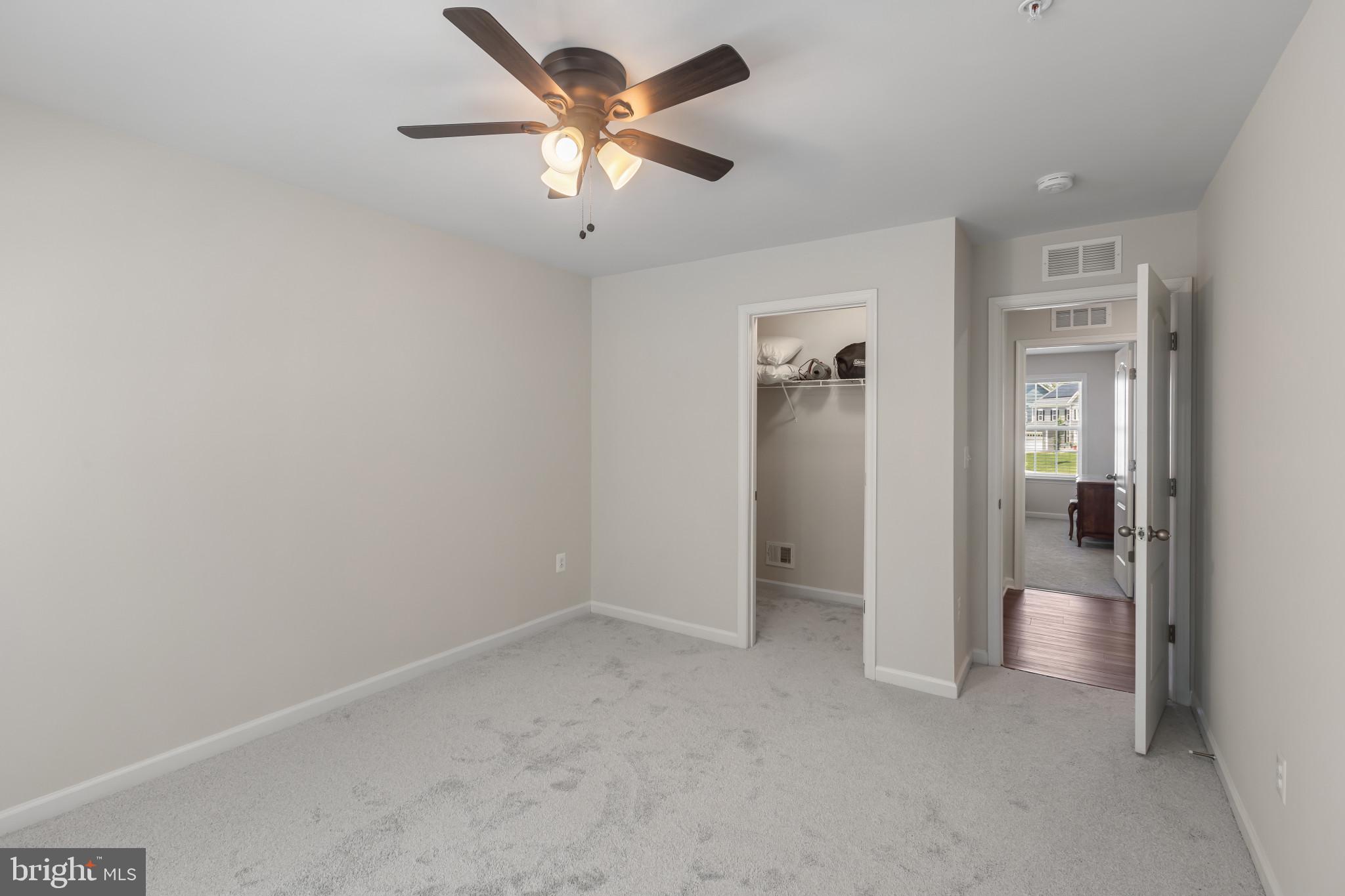 9909 Kildore Way Fort Washington, MD 20744 - Photo 29 of 43 an empty room with closet and a chandelier fan