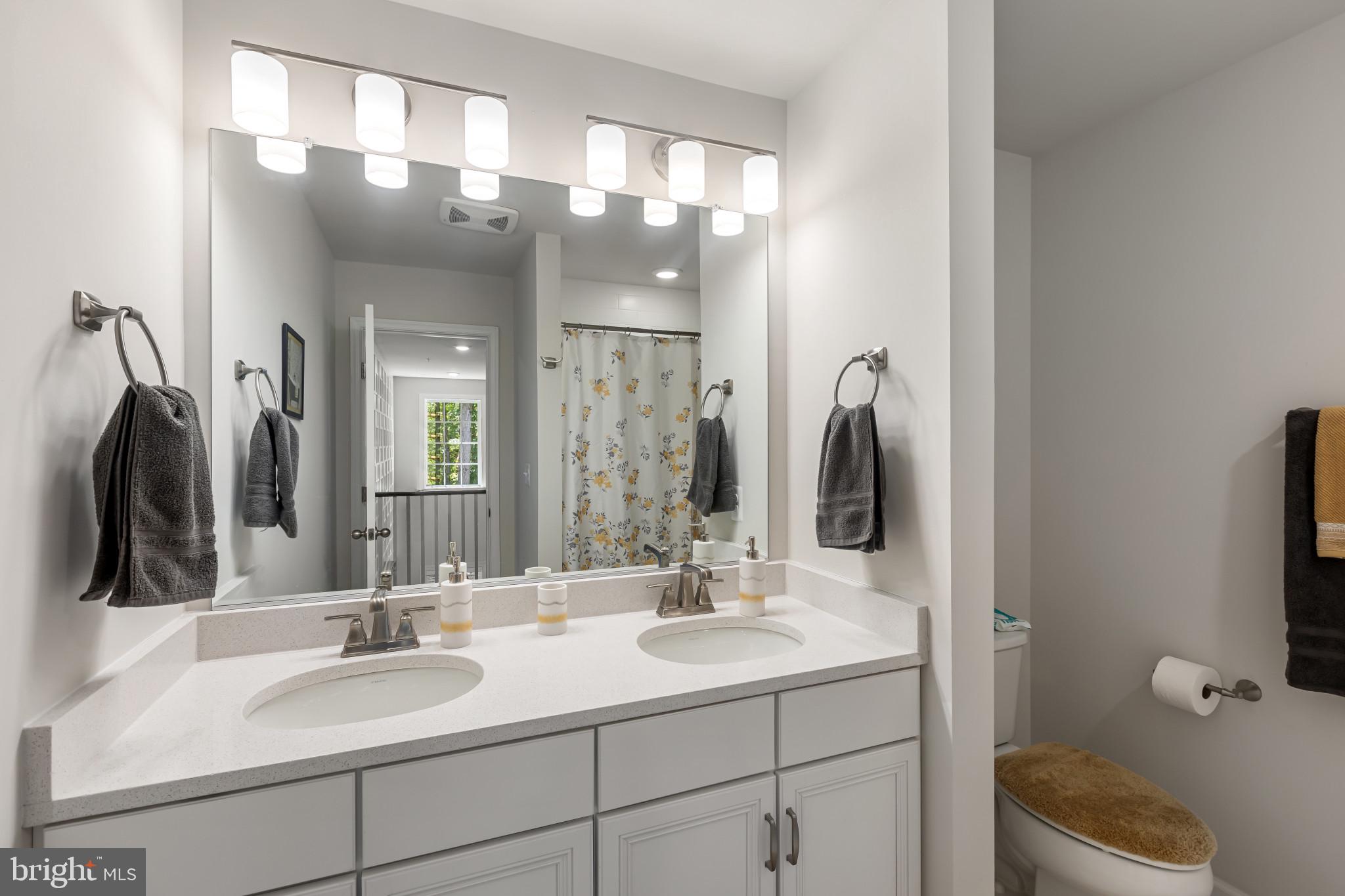 9909 Kildore Way Fort Washington, MD 20744 - Photo 32 of 43 a bathroom with a double vanity sink and a mirror
